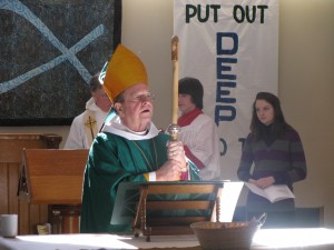 The Bishop prepares to bless the congregation at the conclusion of the Eucharist.