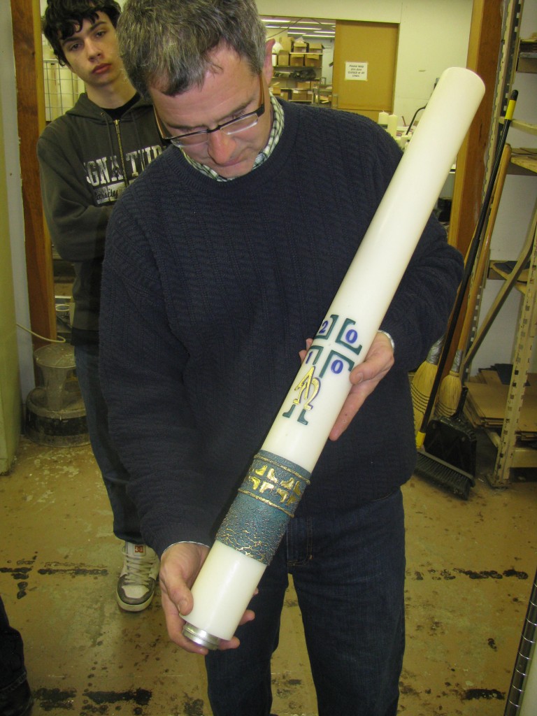 Martin Marklin displays one of his company's hand-crafted Paschal candles.