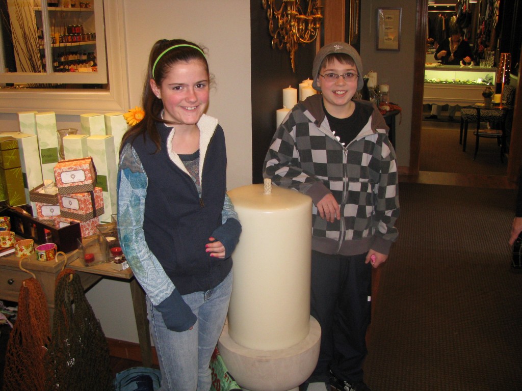 Tammi and Garrick pose beside "Big Bertha," the fattest candle Marklin makes.