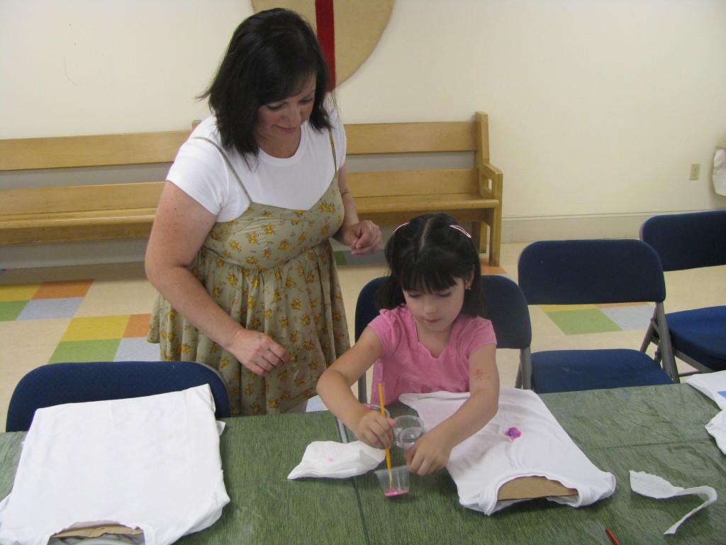 Annabelle decorates her T-shirt with garden designs for the parade.