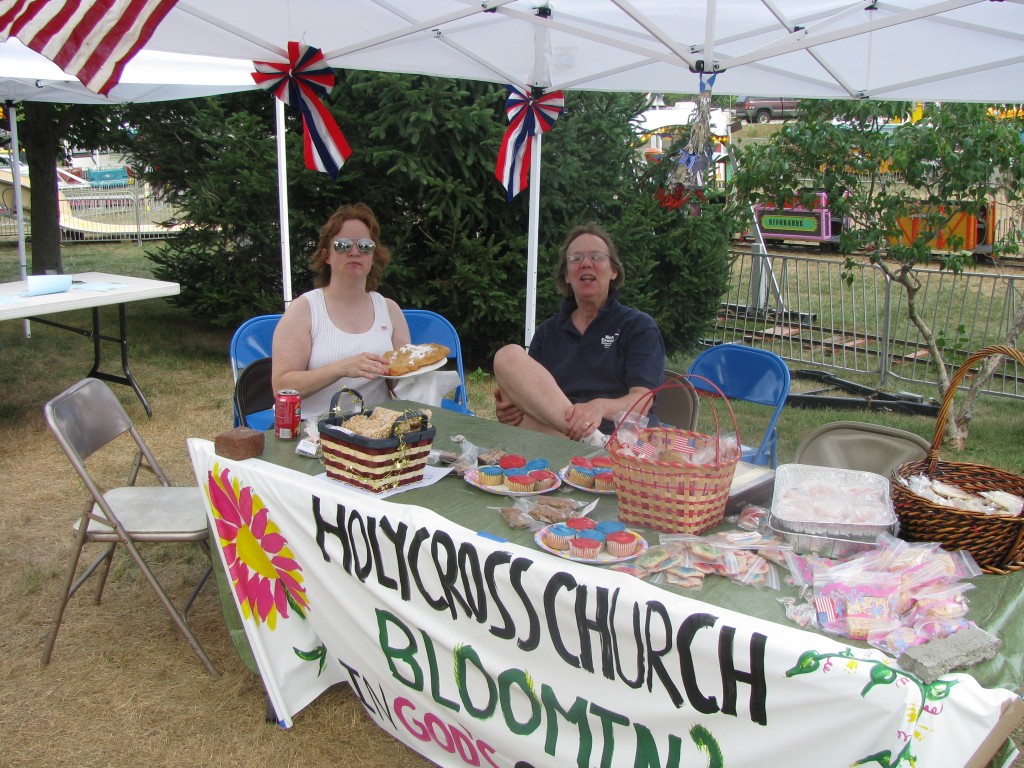 Yvette Desmarais and Anne McCausland try to move baked goodies in the afternoon heat.