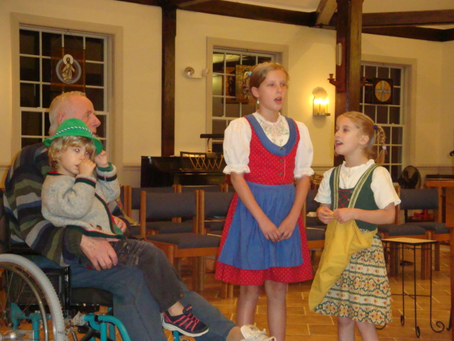 The Douzanis children, dressed in Tyrolean costume, sang some German songs with their grandfather.