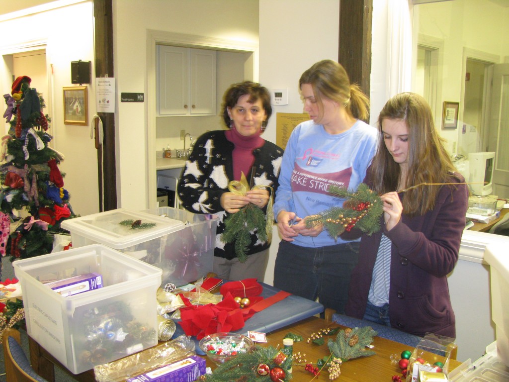 Laura Starr-Houghton, Bobbi-Jo Plamondon and Monica Houghton tie bows and swags.